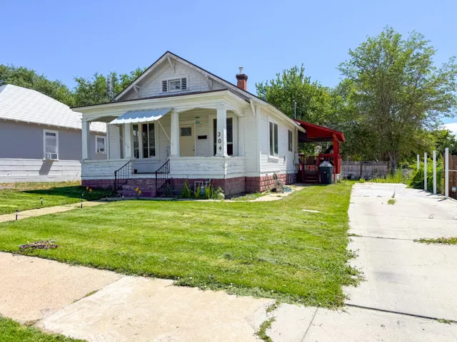 Charming bungalow with a prominent front porch and white column supports
