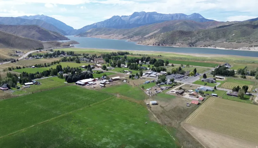 Expansive green fields bordering a community with diverse buildings and structures