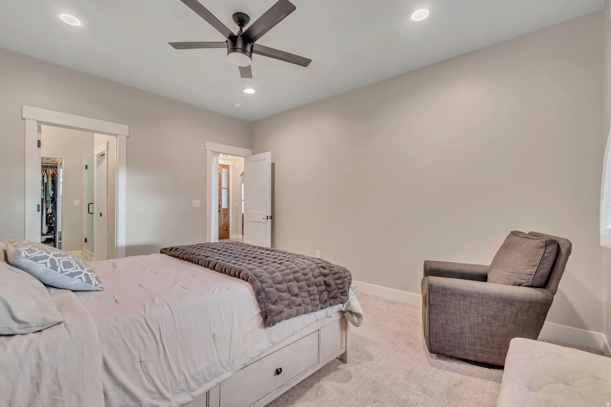 Neutral-toned bedroom featuring recessed lighting and a ceiling fan with integrated illumination