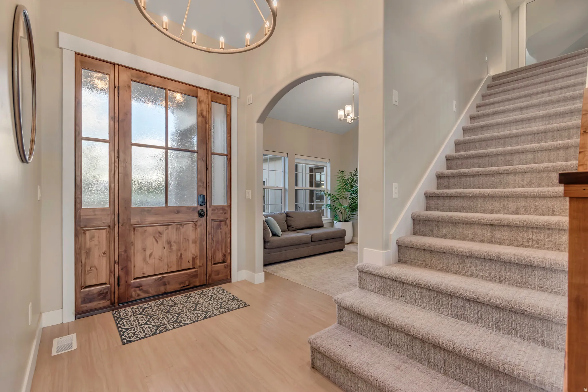 Entry foyer featuring a wood-finish double front door with frosted glass panels and a sidelight