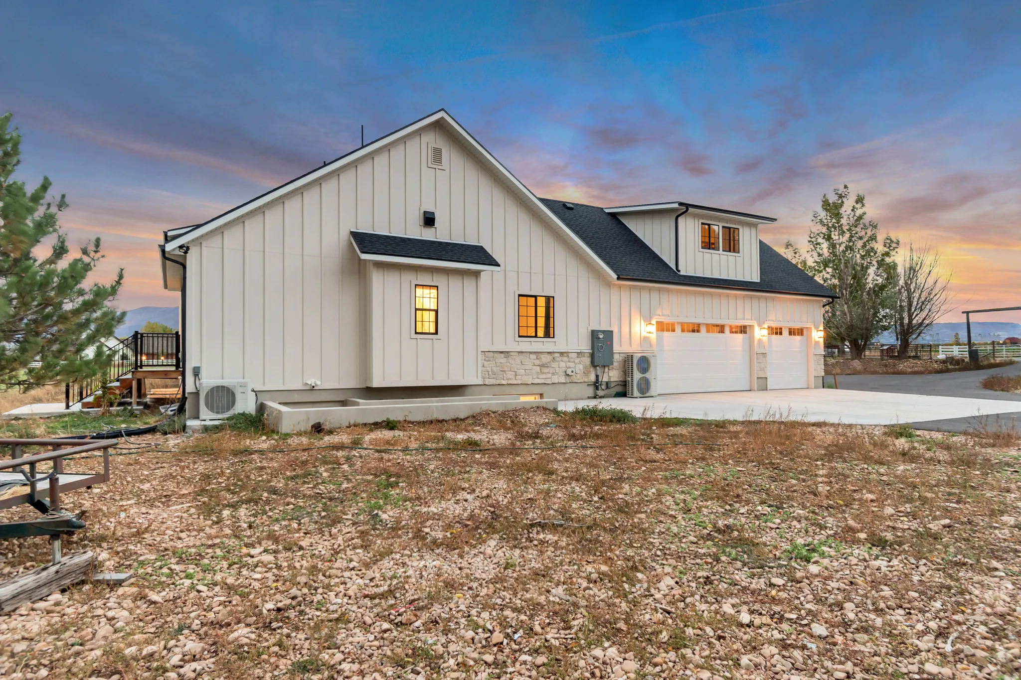 White board-and-batten siding with stone accents