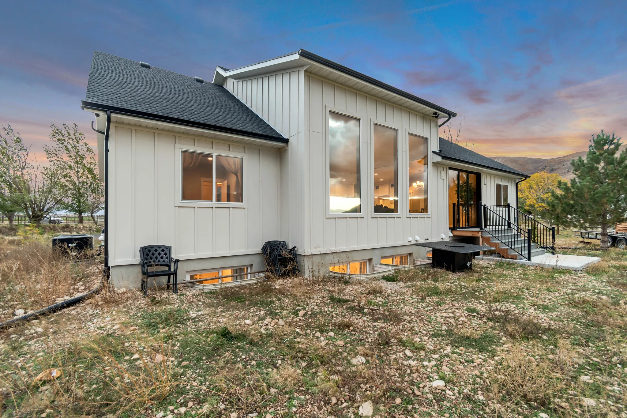 Contemporary exterior featuring vertical siding and a dark shingle roof