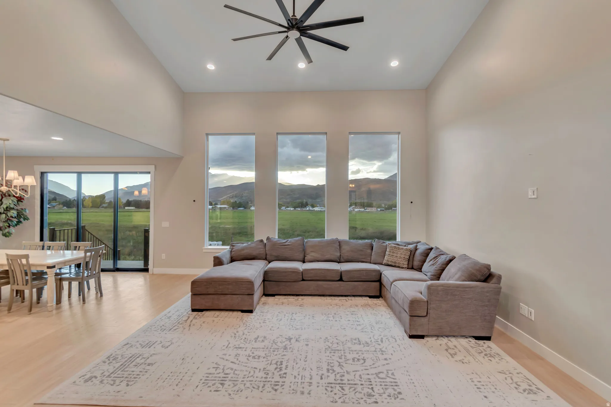 Spacious living area featuring high ceilings and light wood-finish flooring