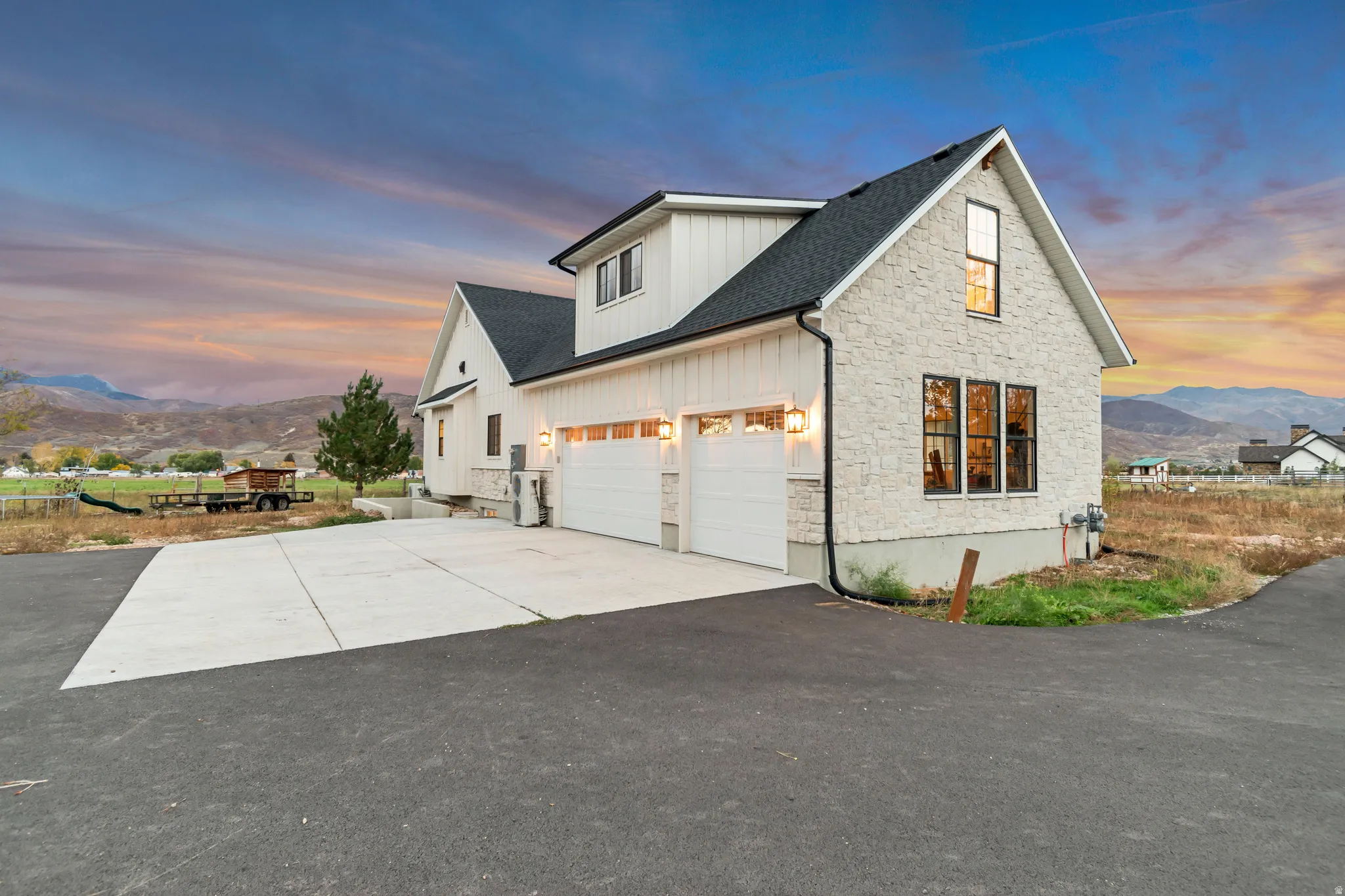Modern farmhouse exterior featuring board and batten siding and stone accents