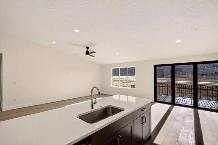 Kitchen island featuring an undermount stainless steel sink and gooseneck faucet