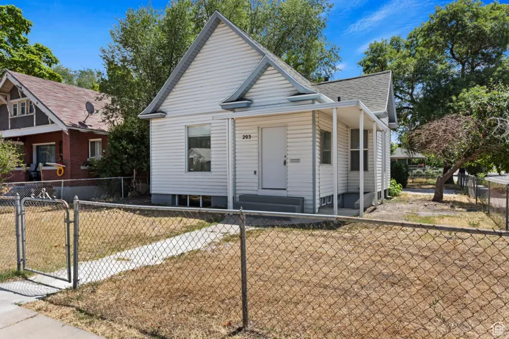 White siding exterior with a covered porch entry