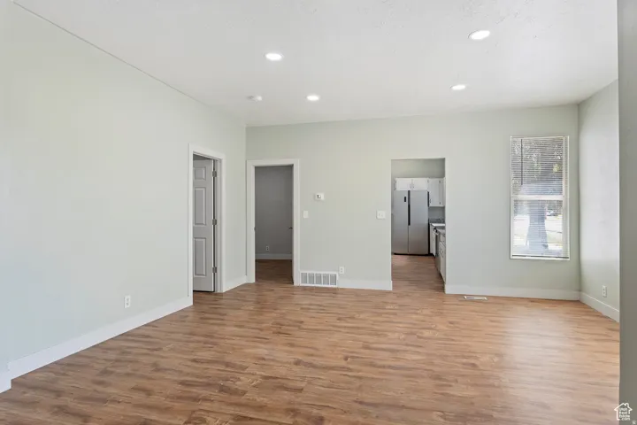 Bright interior space featuring wood-finish flooring, recessed lighting, and light-toned wall paint