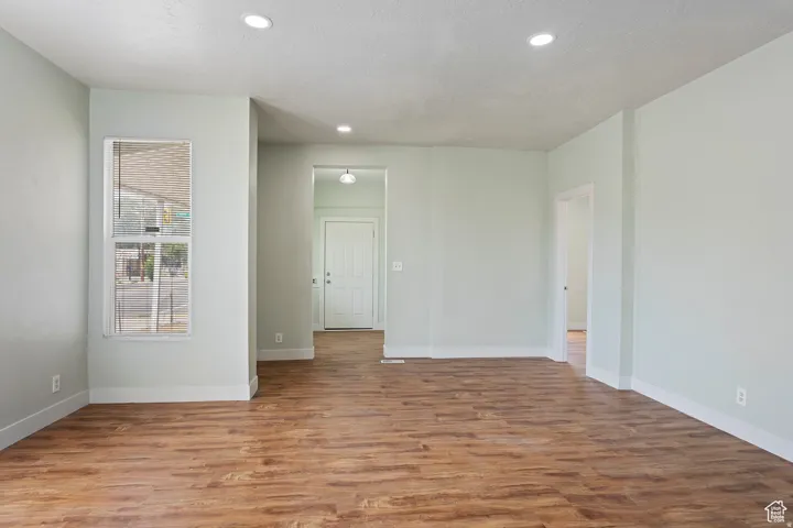 Spacious interior featuring wood-finish flooring, recessed lighting, and a neutral wall palette