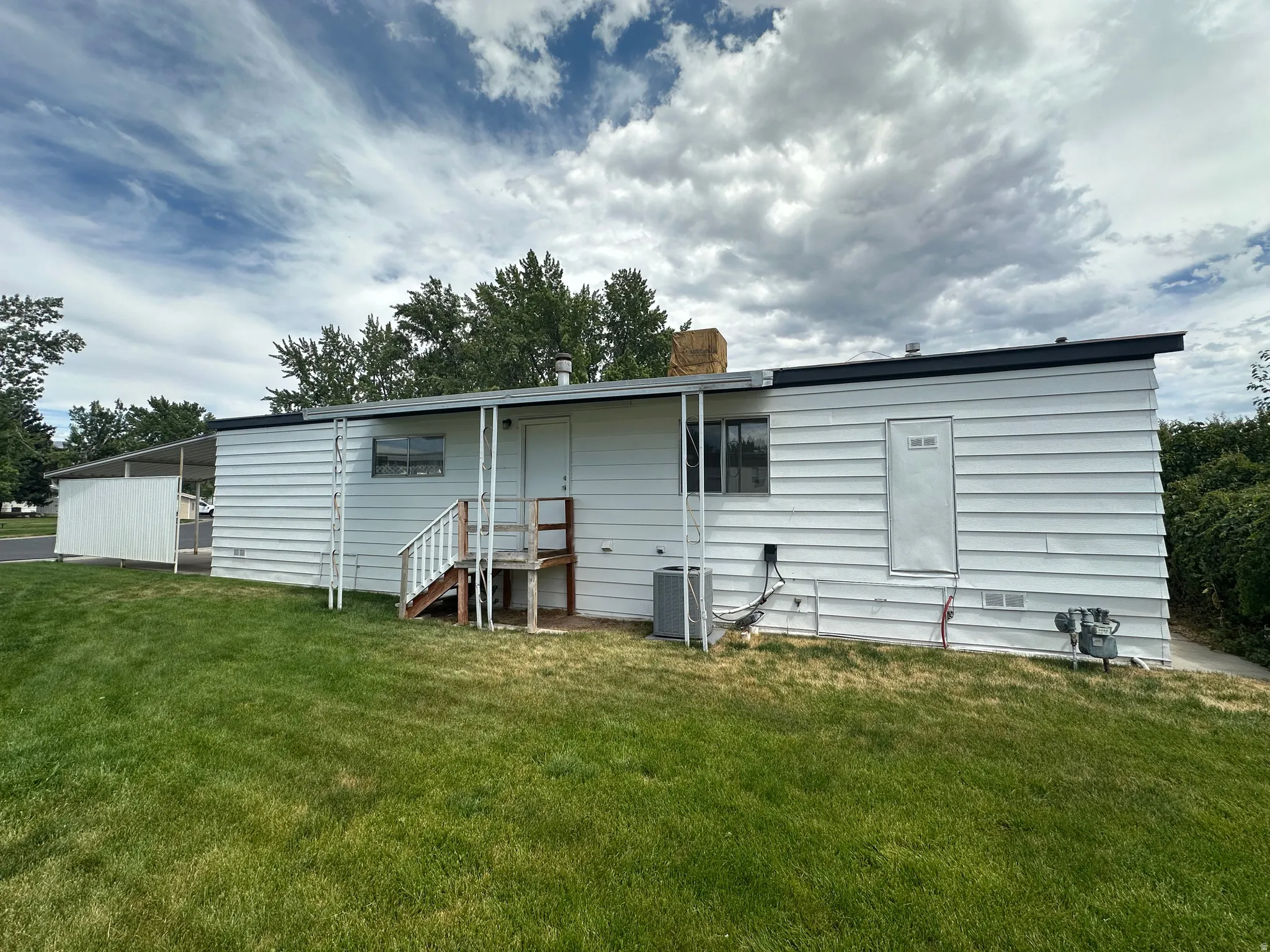 White horizontal siding exterior with a dark trim roofline