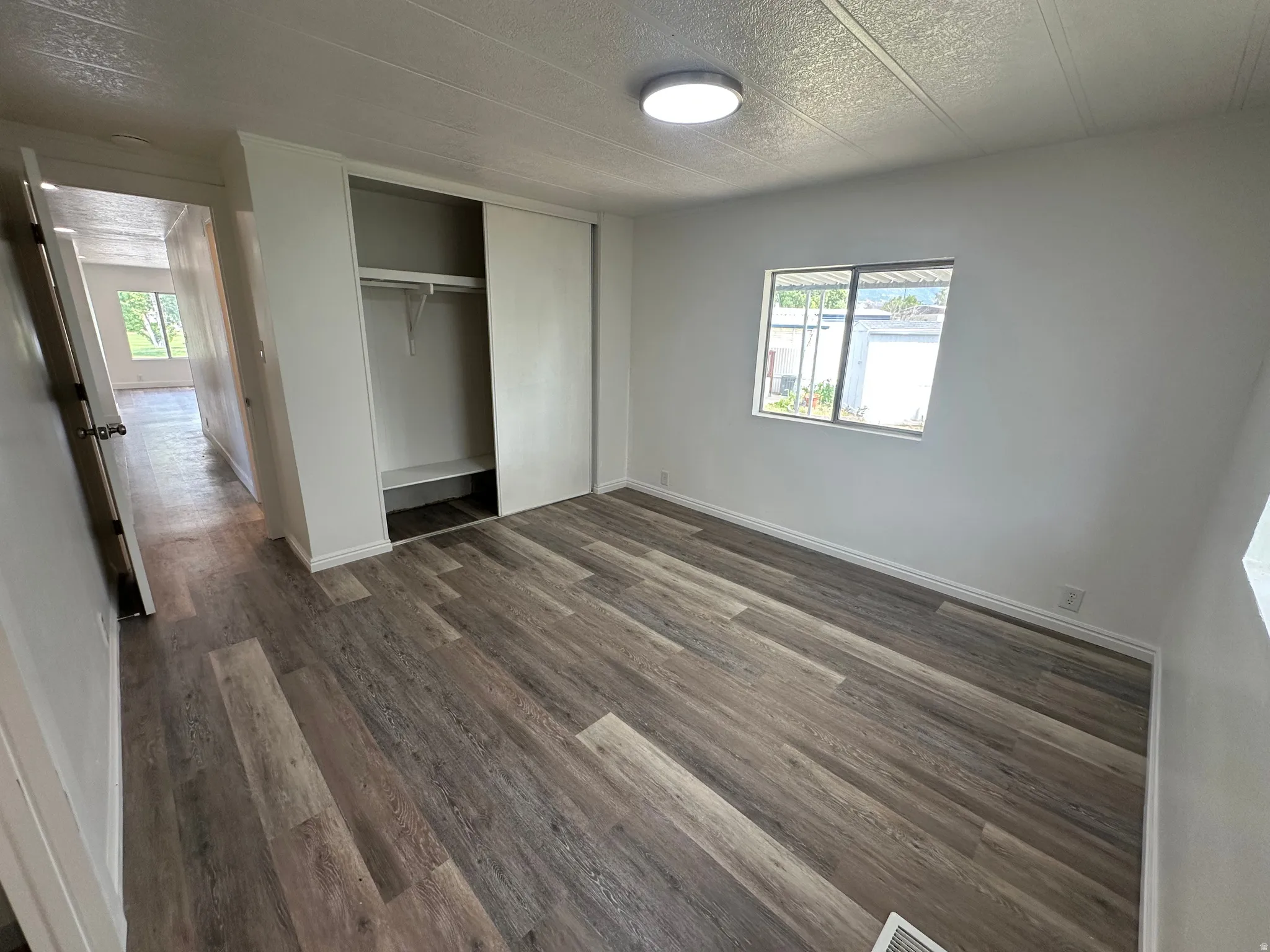 Room featuring wood-finish flooring and a neutral color palette