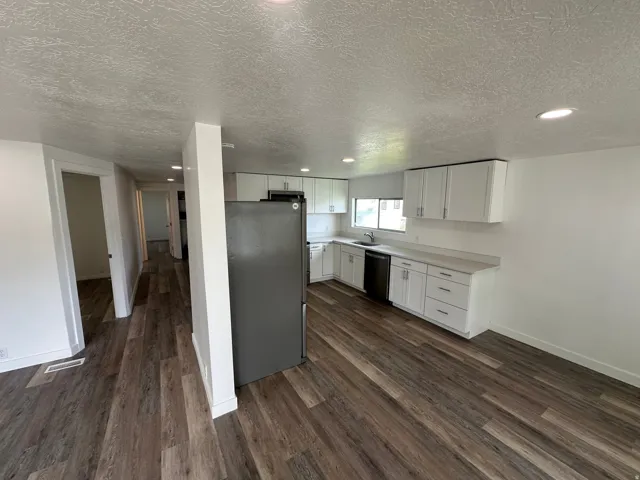 Modern kitchen featuring white cabinetry, light countertops, and integrated appliances