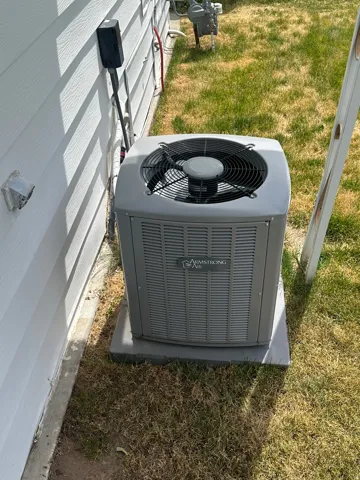 Armstrong Air outdoor HVAC unit situated on a concrete pad