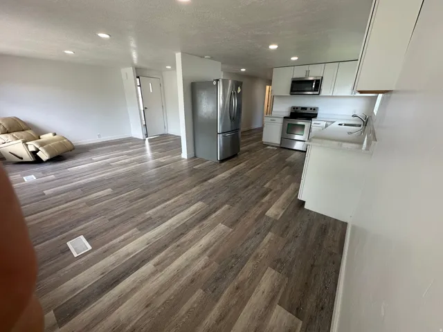 Open-concept living area featuring wood-finish flooring throughout