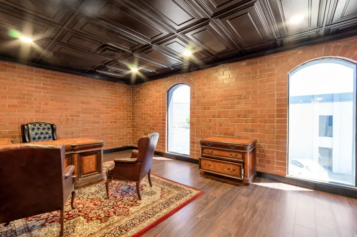 Exposed brick walls complement the wood-finish flooring in this space