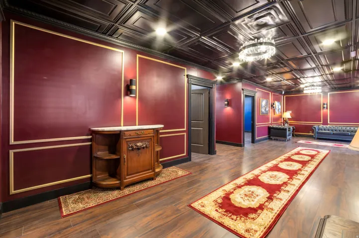 Spacious interior featuring wood-finish flooring and a black coffered ceiling