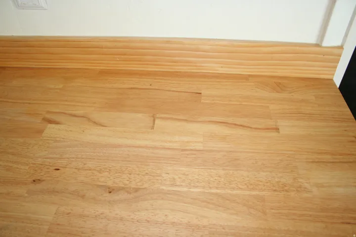 Butcher block countertop with natural wood grain, complemented by a coordinating wood backsplash