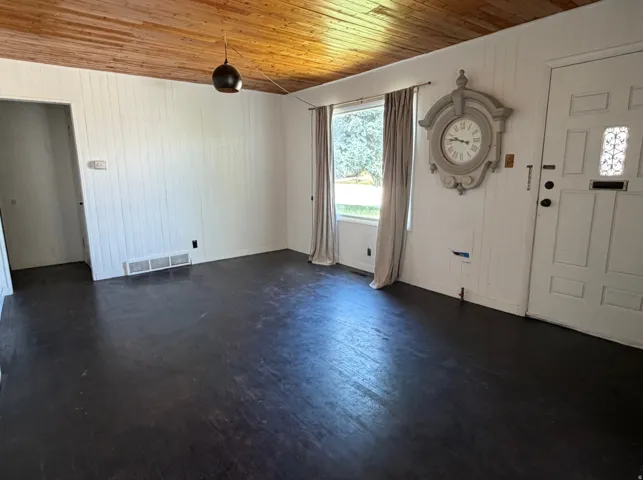 Interior space featuring wood-finish flooring and a wood-paneled ceiling