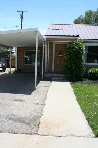 Covered carport with a concrete driveway