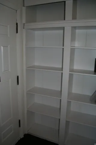 Built-in white shelving providing ample storage