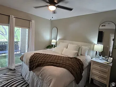 Bedroom with ceiling fan, recessed lighting, and sliding glass door access to an exterior patio area