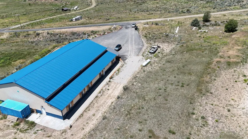 Industrial-style building with a vibrant blue metal roof