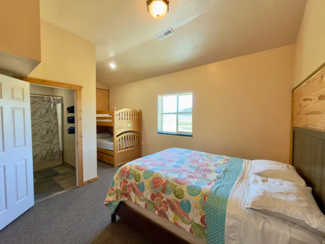 Bedroom featuring a flat ceiling, recessed lighting, and a window with a mountain backdrop