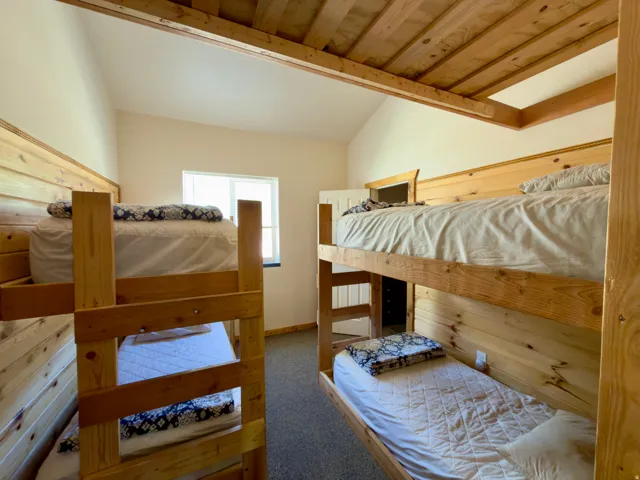 Room featuring exposed wood beam ceilings and wood plank wall accents