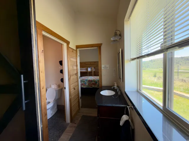 Bathroom vanity with a dark countertop and undermount sink