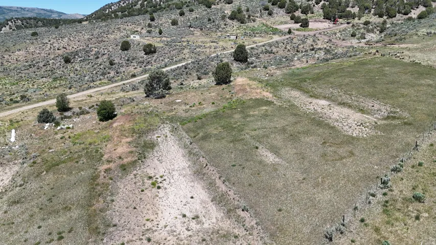 Expansive undeveloped land featuring a cleared, level parcel and natural vegetation