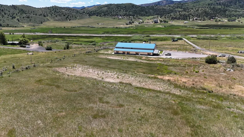 Expansive land parcel featuring natural grasses and distant mountain formations