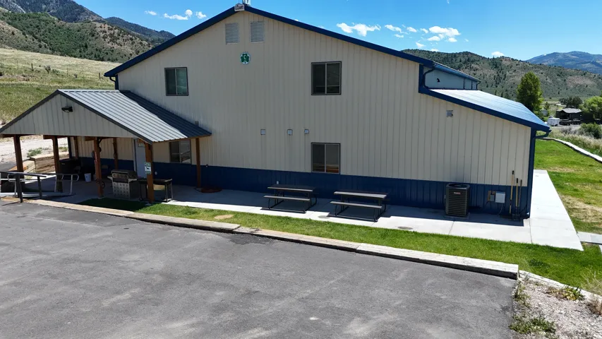 Building exterior featuring a neutral and blue color scheme, a metal roof, and multiple windows