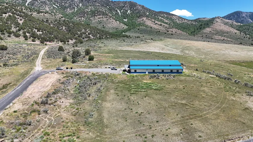 Industrial-style building featuring a vibrant blue metal roof and a multi-level structure