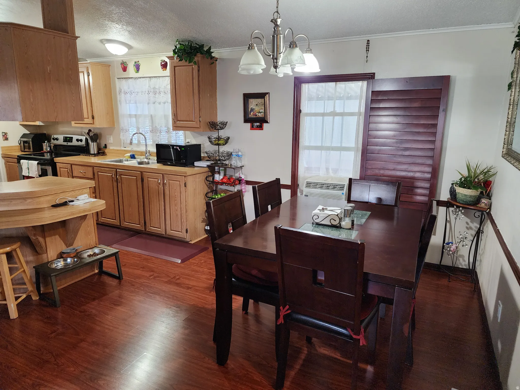 Open-concept kitchen and dining area with wood-finish flooring