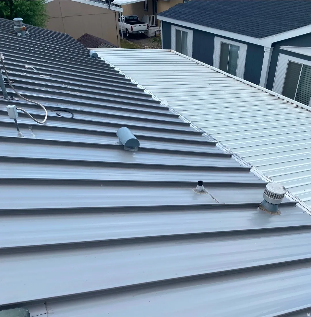 Metal panel roofing featuring a two-tone design, with a darker gray section contrasting a lighter white section