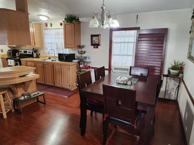 Open-concept kitchen and dining area with wood-finish flooring