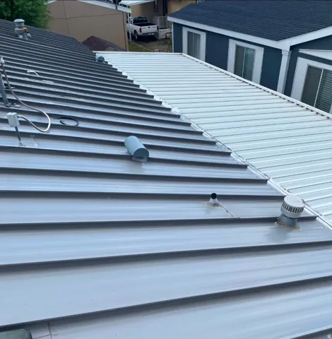 Metal panel roofing featuring a two-tone design, with a darker gray section contrasting a lighter white section