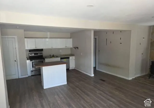 Open-concept living space featuring wood-finish flooring throughout