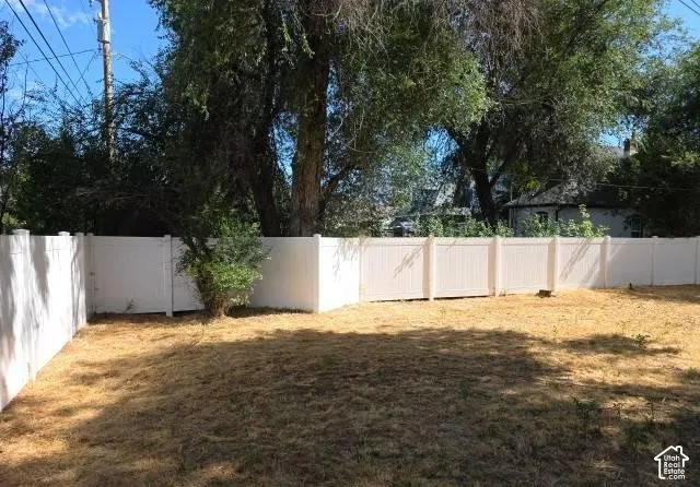 Private backyard with a full perimeter fence and established trees