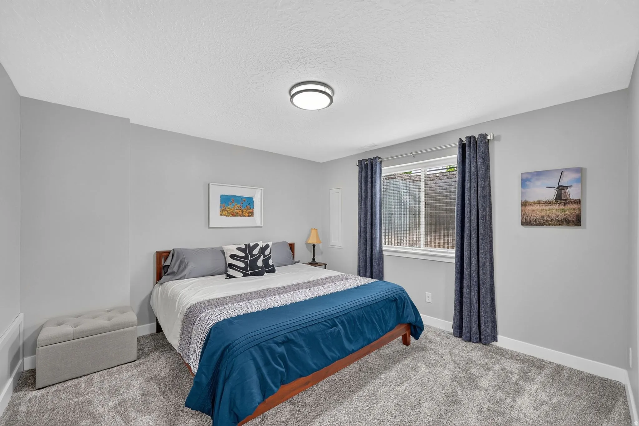 Bedroom featuring light gray wall paint, gray carpet flooring, and a white ceiling