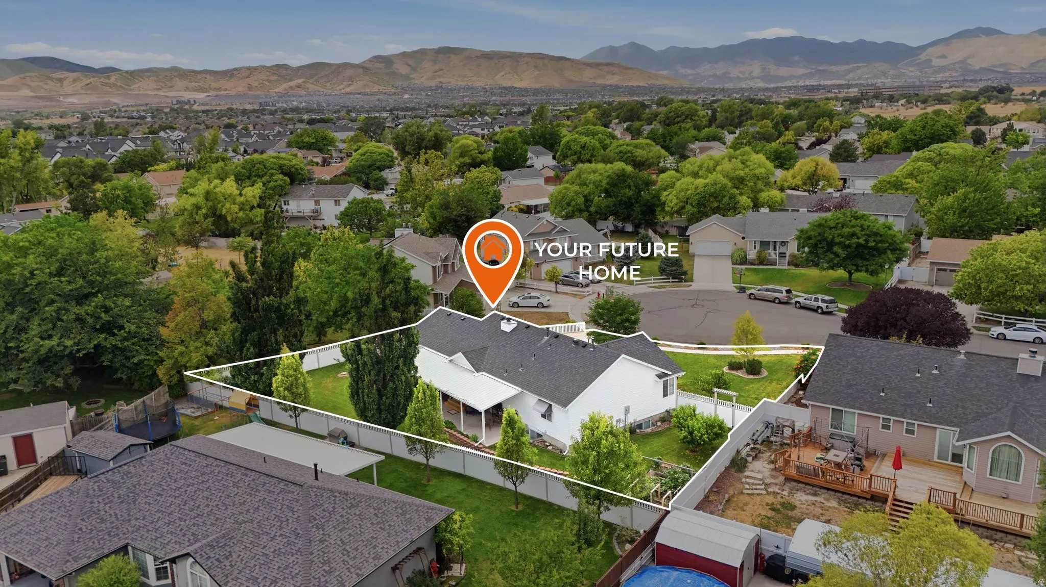 Aerial perspective showcasing a single-story home with a white exterior and dark shingle roof
