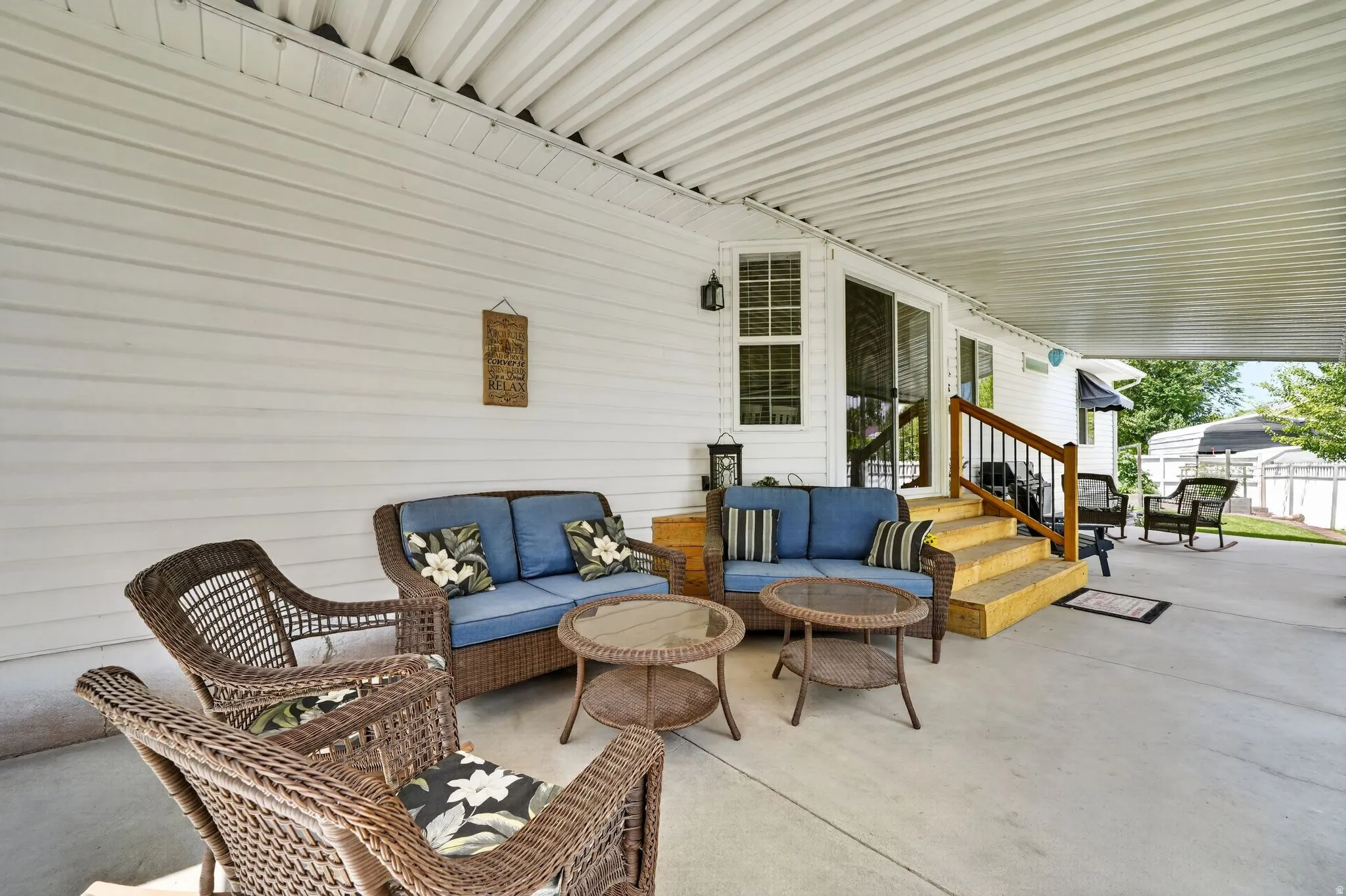 Expansive concrete patio with a full-length covered roof