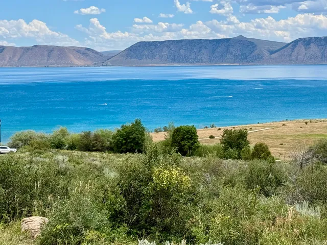Expansive water body with surrounding mountains