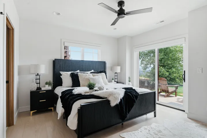 Primary suite featuring new wood flooring, contemporary ceiling fan, recessed lighting, patio & hot tub access