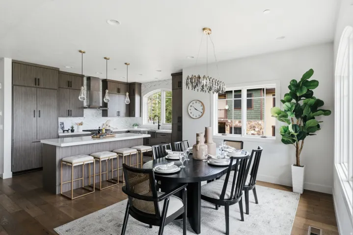 Open-concept kitchen and dining area featuring wood-finish flooring