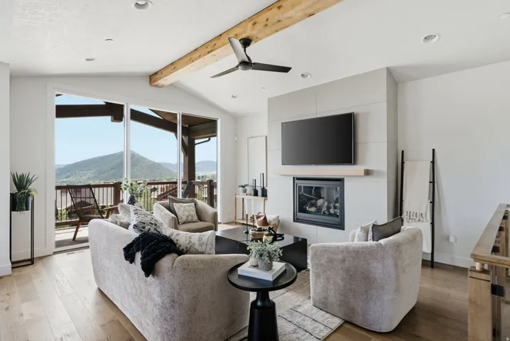 Vaulted living area featuring a wood beam ceiling, recessed lighting, and a contemporary ceiling fan