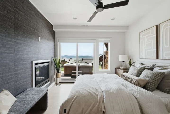 Jr Suite Bedroom featuring a built-in fireplace, sliding glass door, and recessed lighting