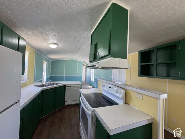Kitchen featuring white countertops, green cabinetry, a white refrigerator, a white dishwasher, and a white electric range with an overhead exhaust fan