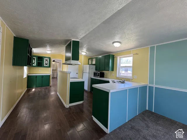Kitchen featuring wood-finish flooring and ample cabinetry
