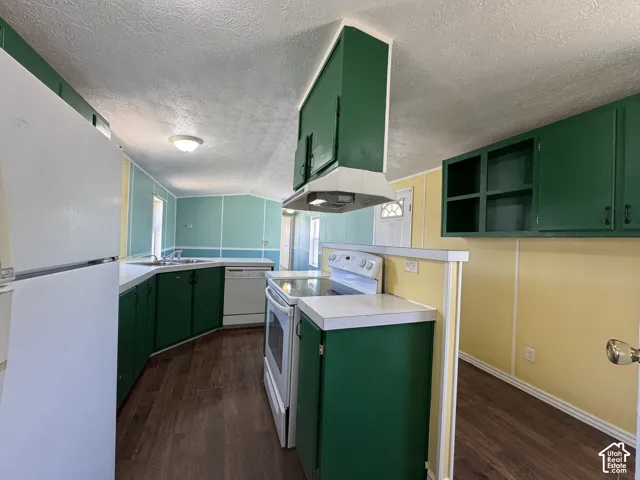 Kitchen featuring wood-finish flooring, green cabinetry, white countertops, and white appliances including a refrigerator, range, and dishwasher