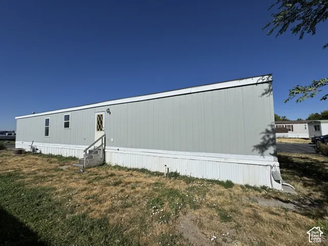 Manufactured home with light blue siding and white trim